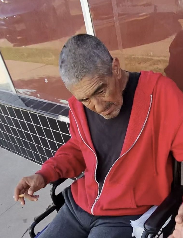 A man in a wheelchair being supported by our outreach team